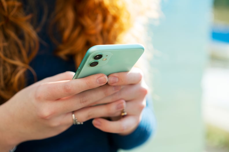 Woman scrolling on her phone, dealing with brain rot.