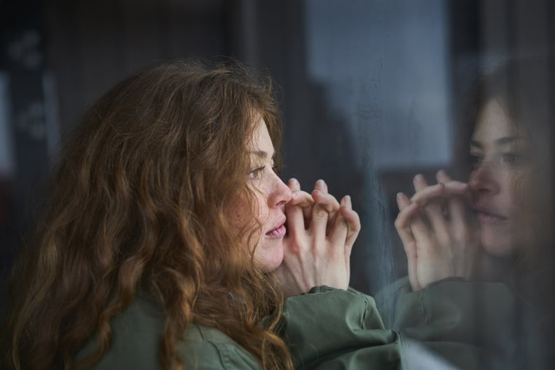 Woman in her winter slump, staring out the window.