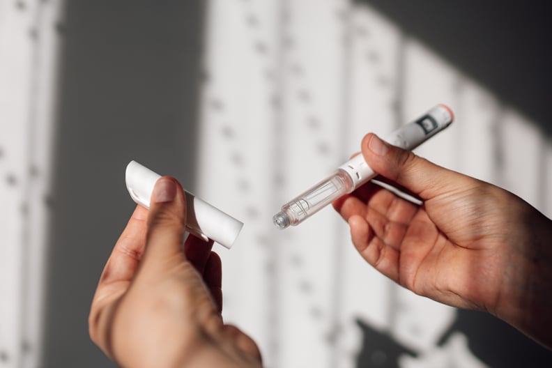 Semaglutide injection pen or cartridge pen held in female hand. 
