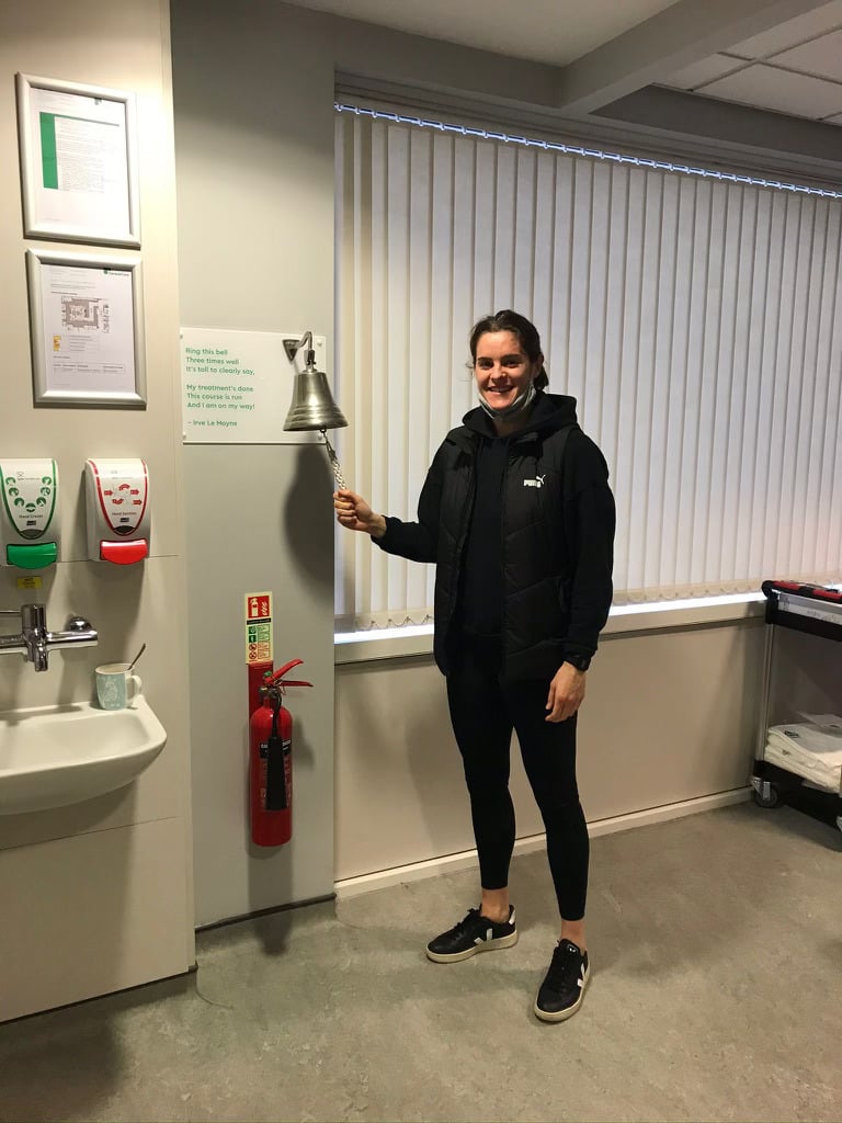 Jen Beattie ringing the bell after finishing cancer treatment.